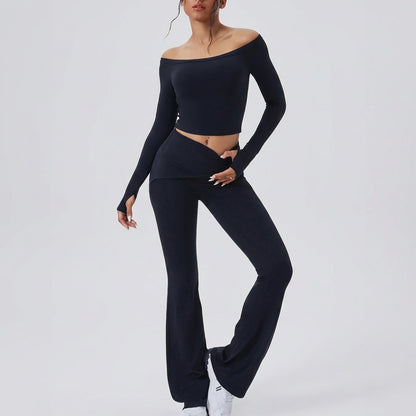 Person in stylish black off-shoulder outfit with sneakers.