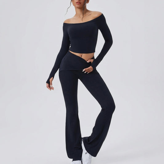 Person in stylish black off-shoulder outfit with sneakers.