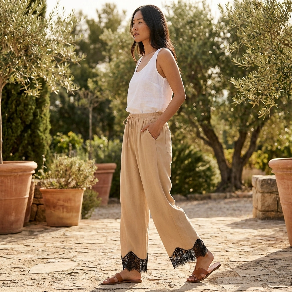 A woman in casual attire walks outdoors among potted plants.