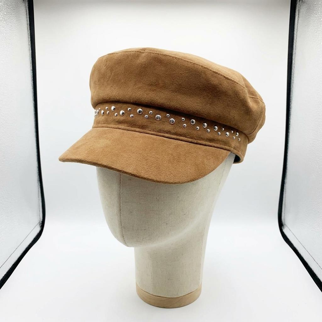 Tan suede cap with rhinestones on a mannequin head.