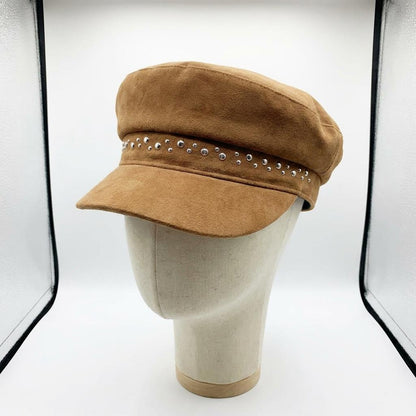 Tan suede cap with rhinestones on a mannequin head.