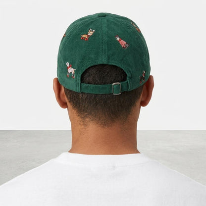 Back view of a person wearing a green cap embroidered with small dogs.