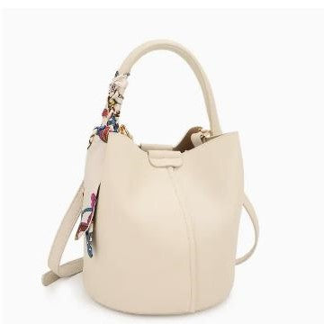 Cream bucket bag with a colorful patterned handle and keychain.