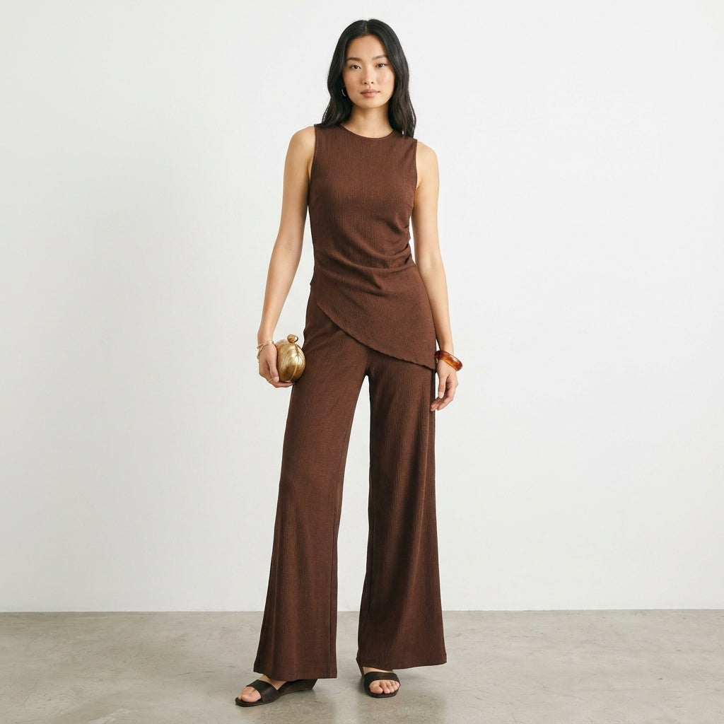 Person in a stylish brown outfit holding a small clutch.