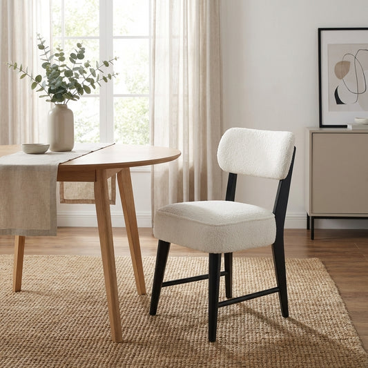 Modern chair with white cushion and dark wooden legs.