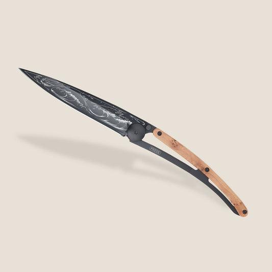 Elegant wooden-handled knife with intricate blade design.