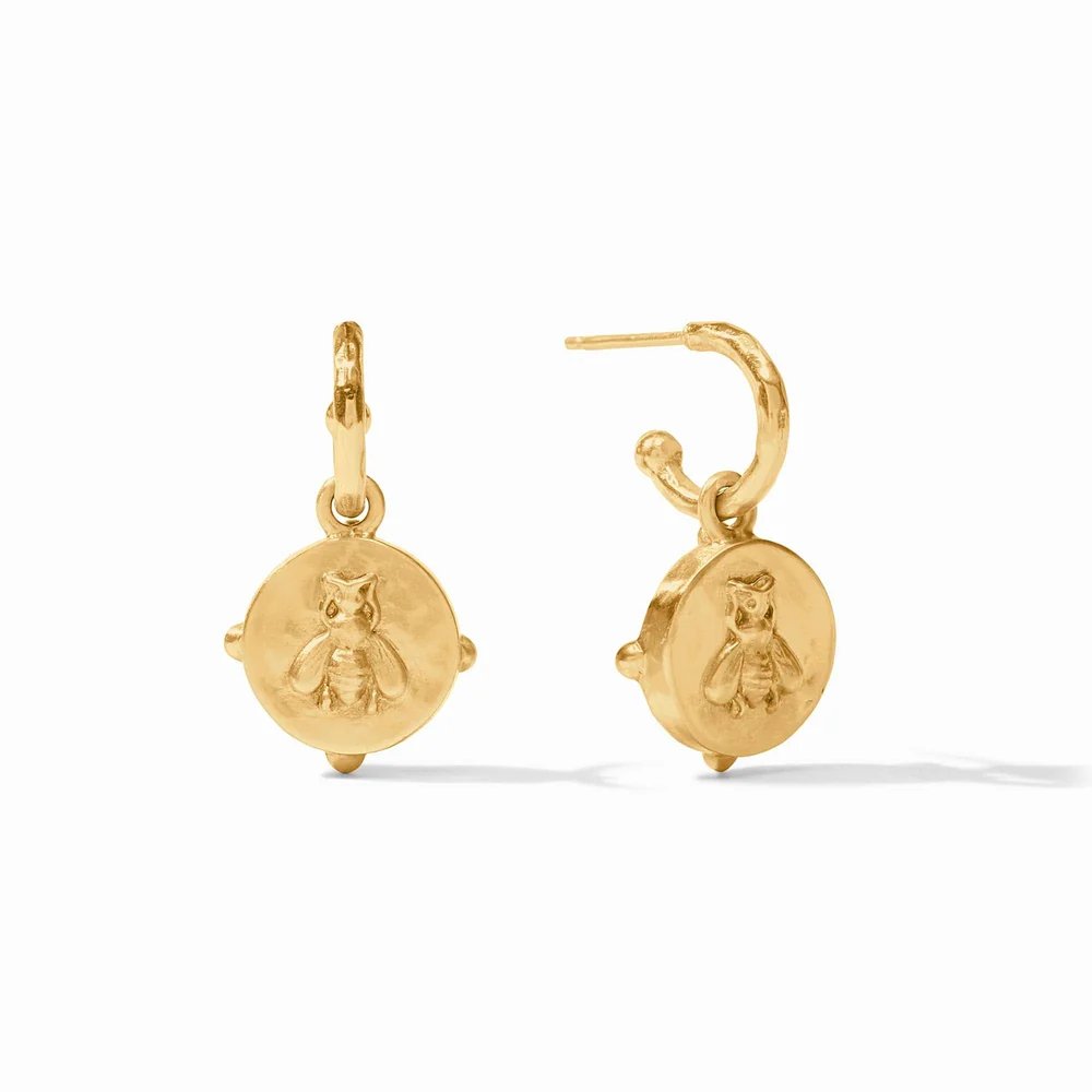 Pair of gold hoop earrings with round charms engraved with tiny owls.