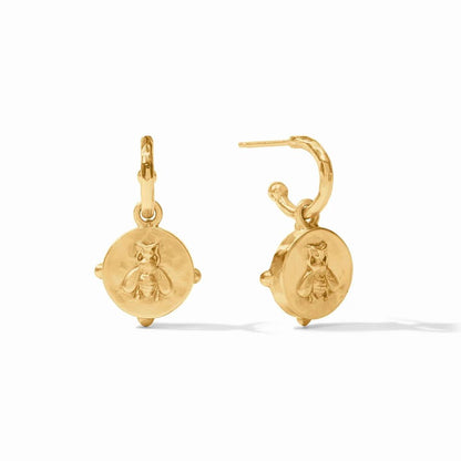 Pair of gold hoop earrings with round charms engraved with tiny owls.
