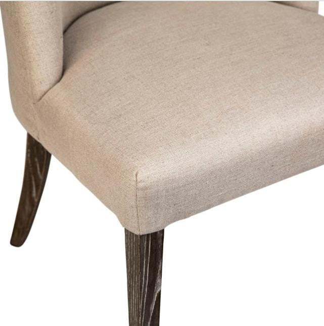 Beige upholstered chair with dark wooden legs.
