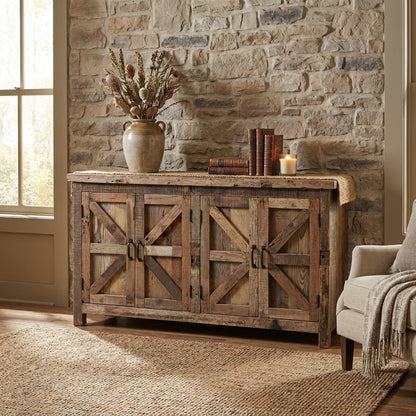 Rustic room with stone wall, wooden sideboard, vase, books, and a candle.