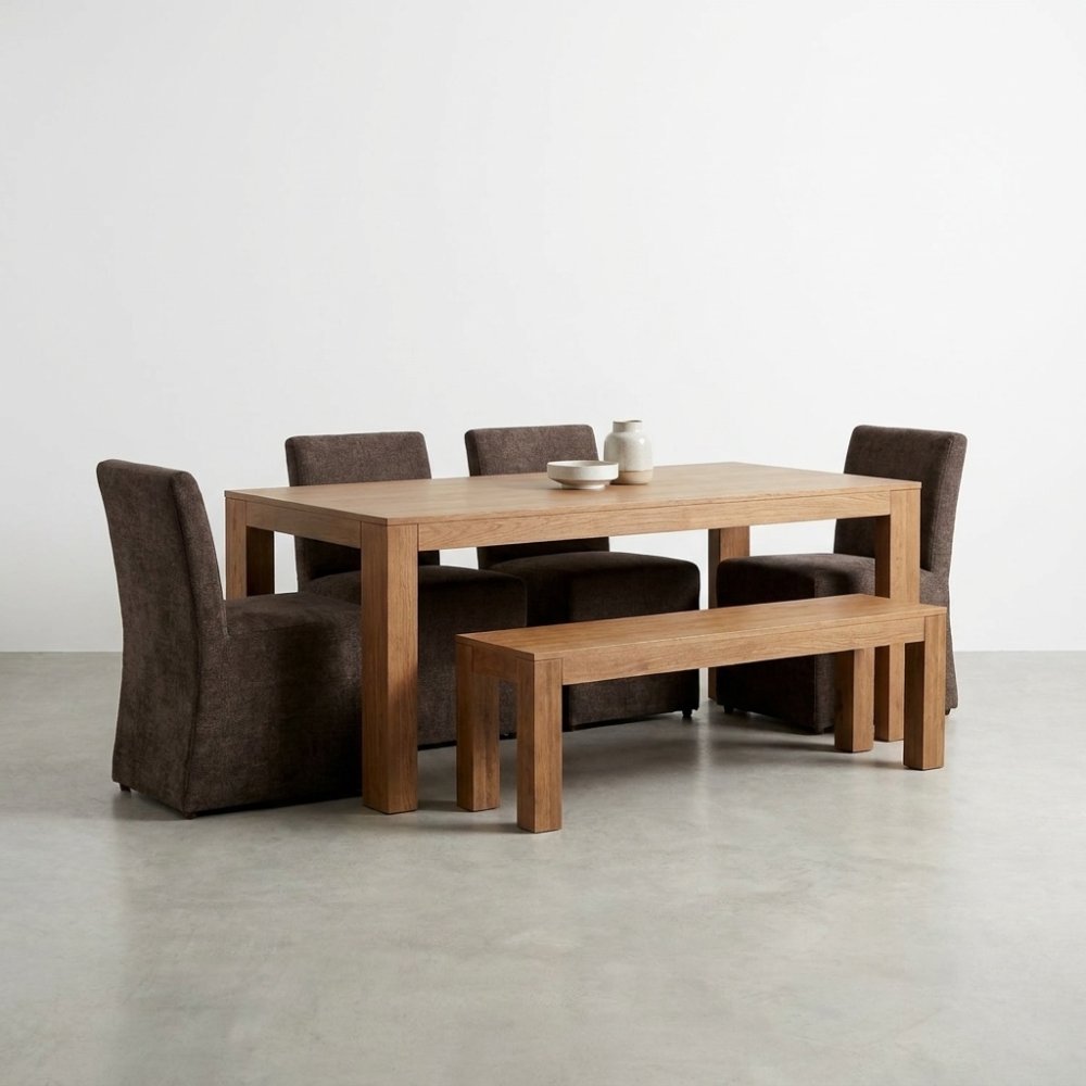 Wooden dining table set with chairs and bench on a minimalist floor.
