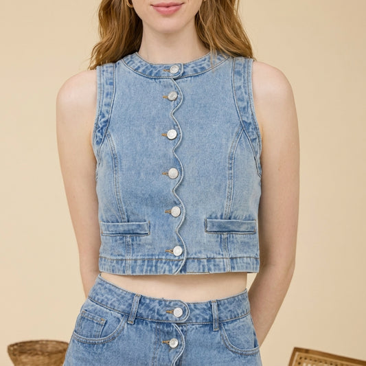 Woman in a denim set with wavy button design.