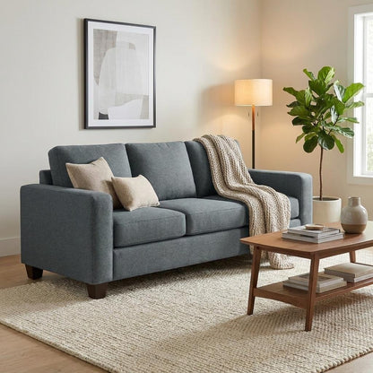 Cozy living room with grey sofa, plants, and wooden coffee table.