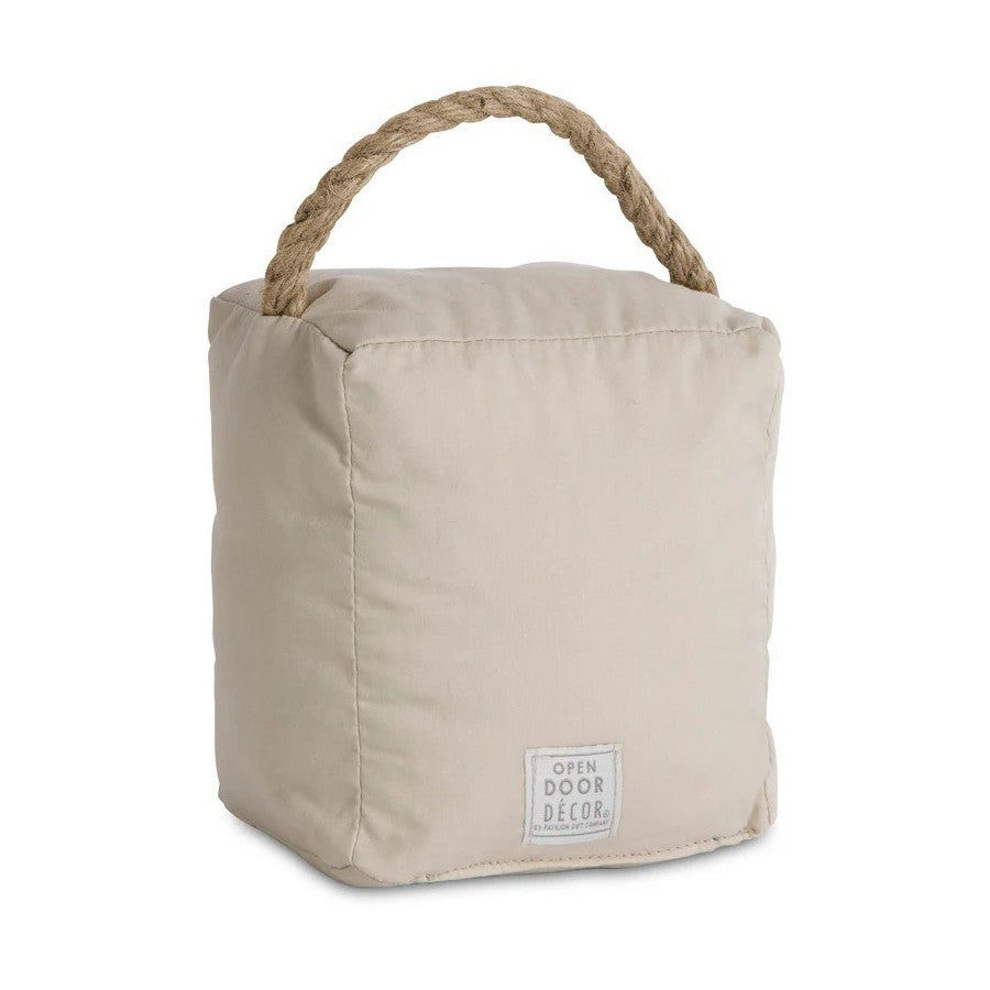 Beige fabric doorstop with rope handle and label.