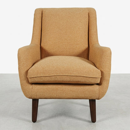 Beige mid-century modern armchair with wooden legs.