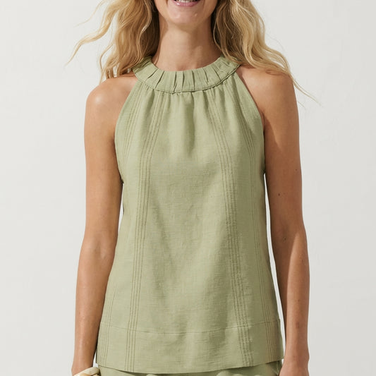 Woman in a sleeveless, light green top with ruffled neckline.