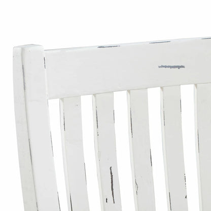 Close-up of a white wooden chair with a distressed finish.