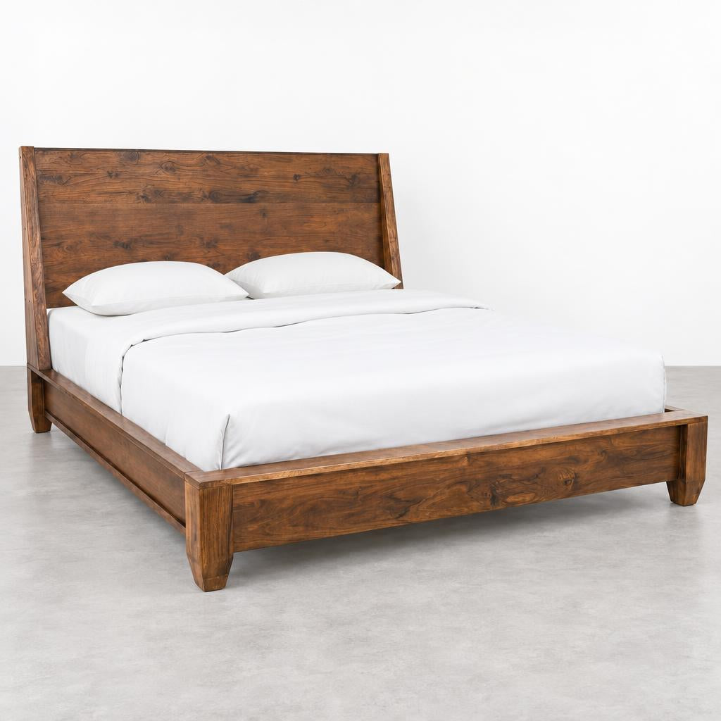 Wooden bed frame with white bedding and two pillows, set in a bright room.