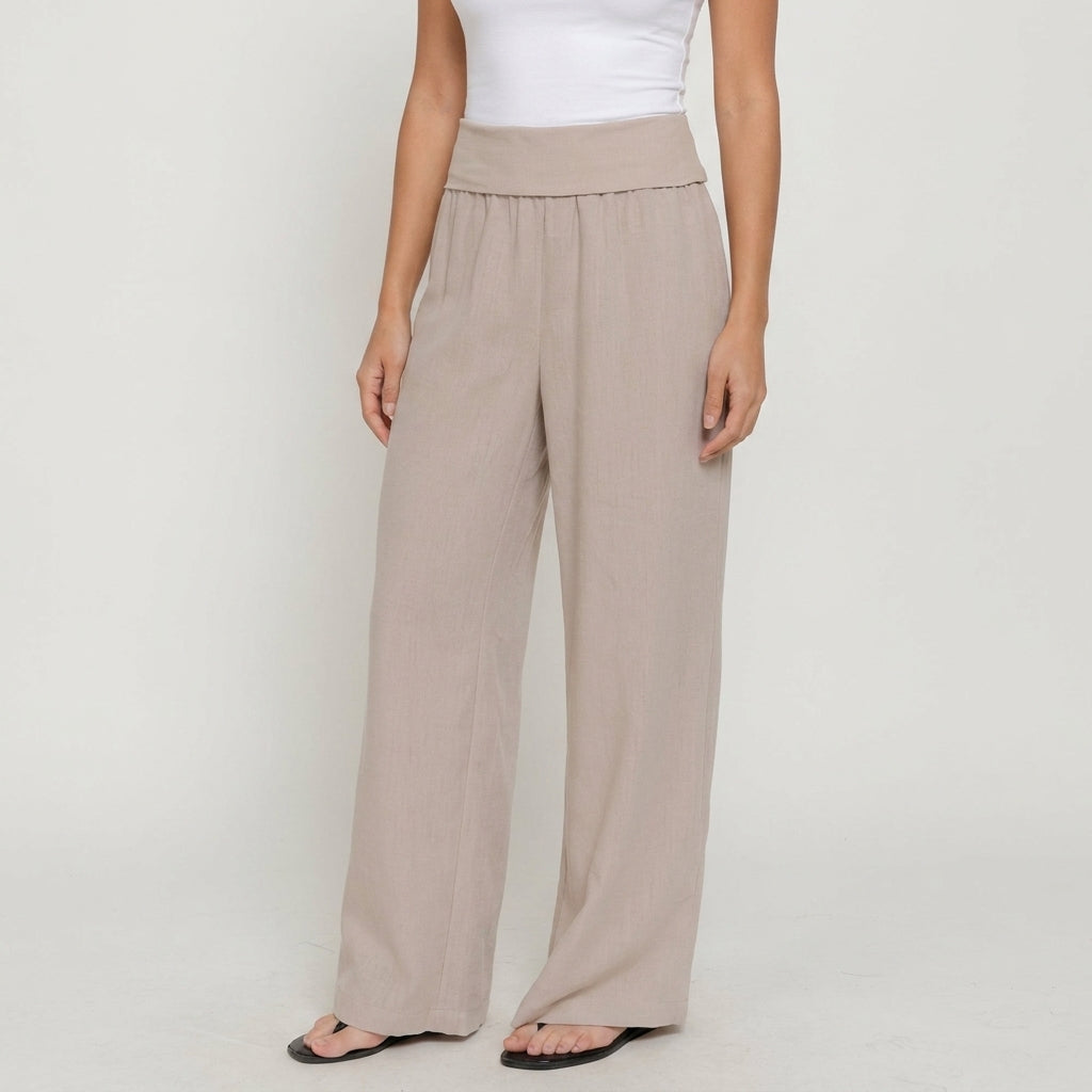 Woman in beige wide-leg pants and white top.