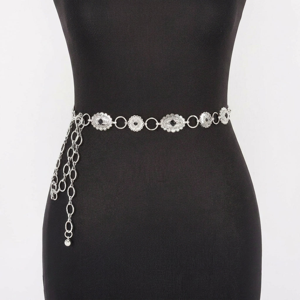 Silver chain belt with ornamental design on a mannequin.