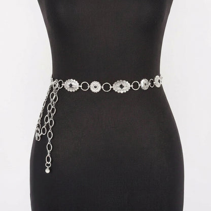 Silver chain belt with ornamental design on a mannequin.