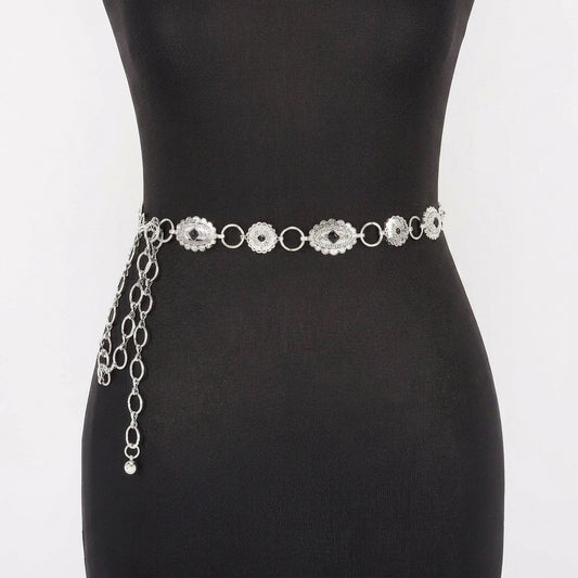Silver chain belt with ornamental design on a mannequin.