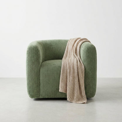 Green textured ottoman with a rounded shape.