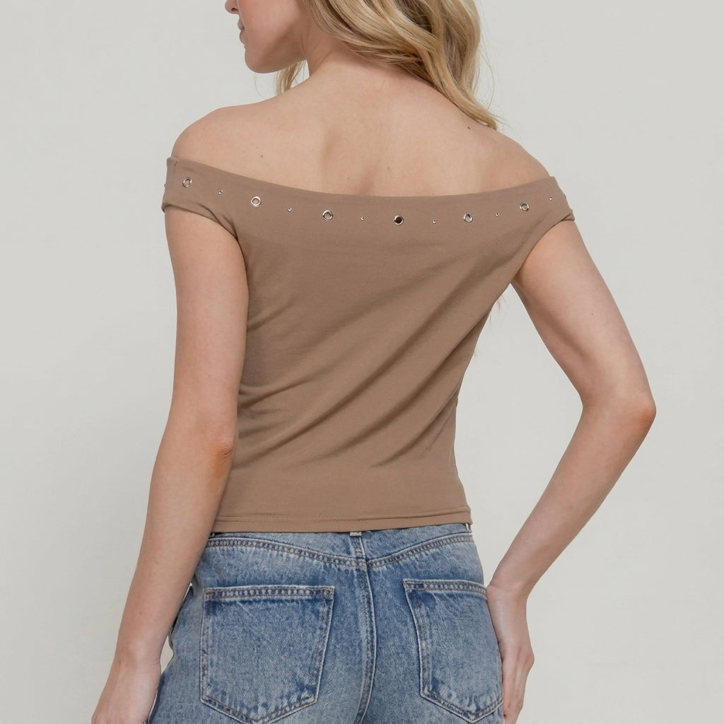 Woman in off-shoulder top and jeans viewed from behind.