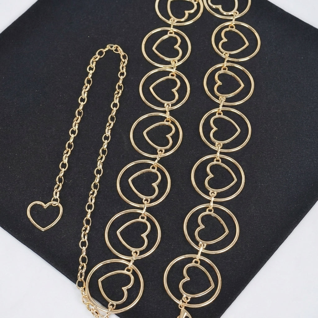 Gold heart chain jewelry on black background.