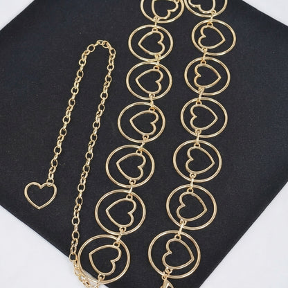 Gold heart chain jewelry on black background.