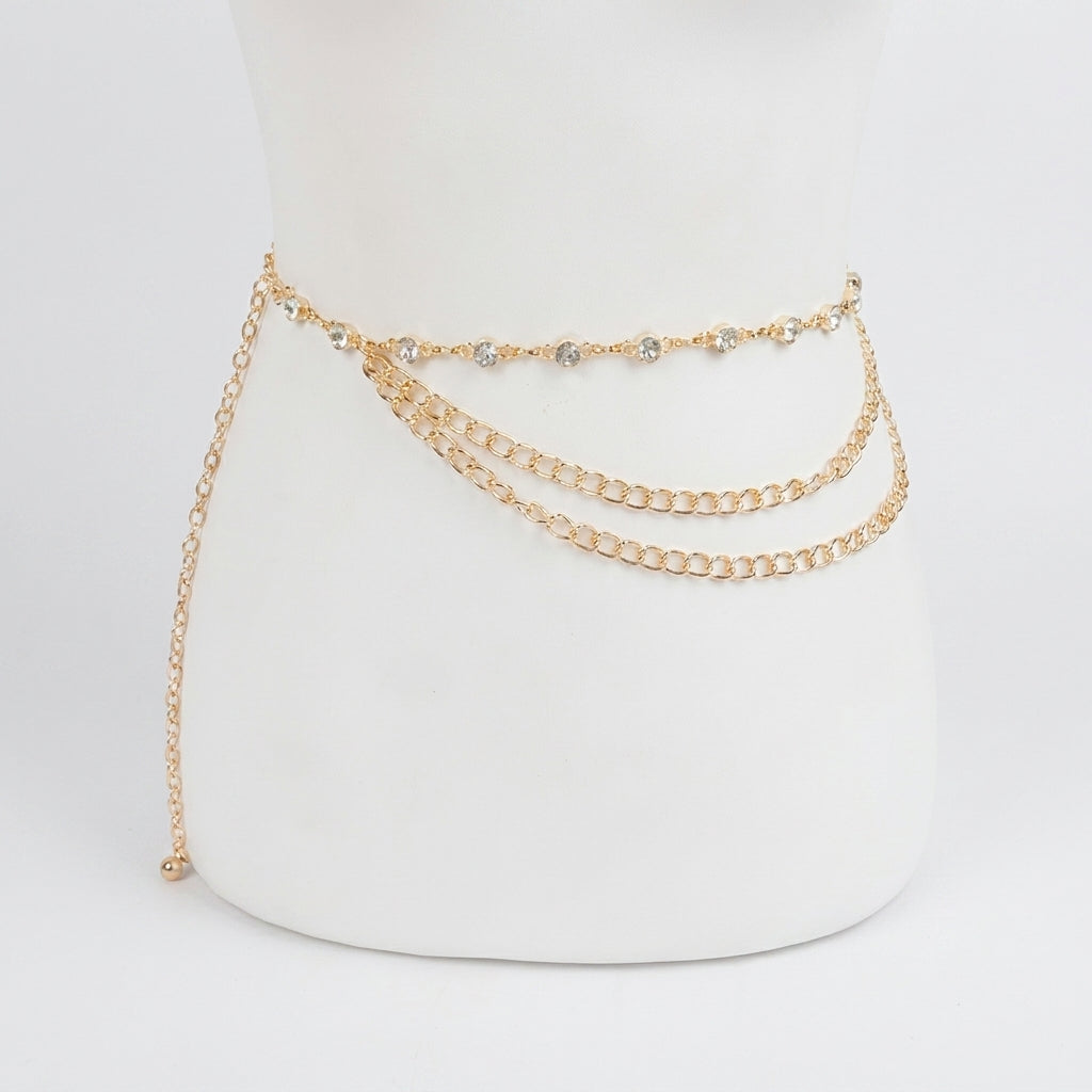 Gold chain belt with rhinestone detailing on a white mannequin.