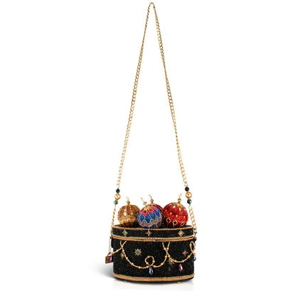 Ornate black handbag with colorful, embellished crown accents and a gold chain strap.