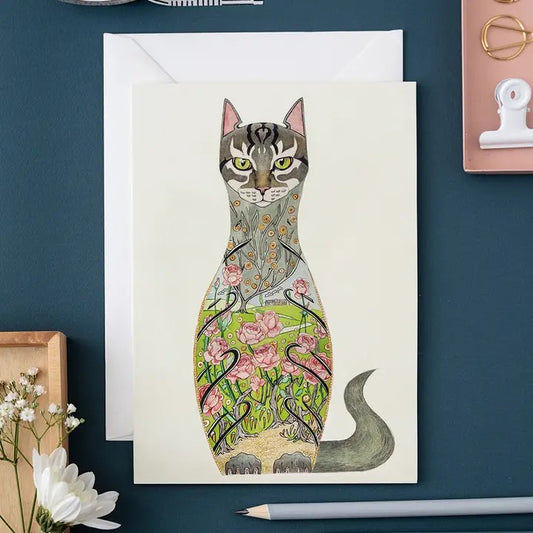 Illustrated cat design with floral patterns on a card and envelope.