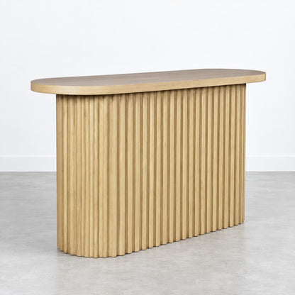 Wooden table with vertical slats and an oval top.