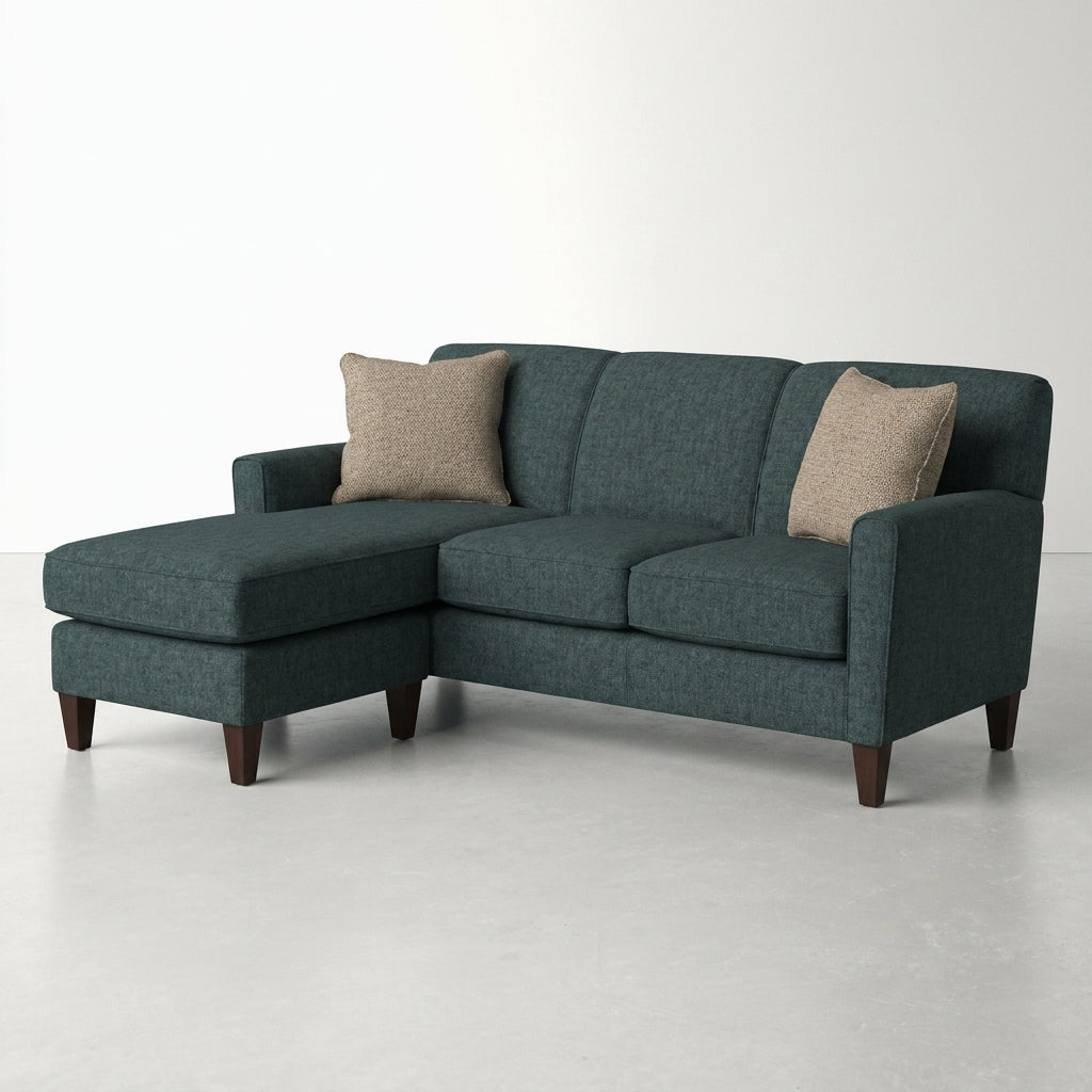 Dark gray sectional sofa with two beige pillows.