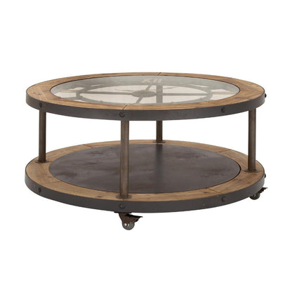 Round industrial coffee table with glass top and wooden accents on wheels.