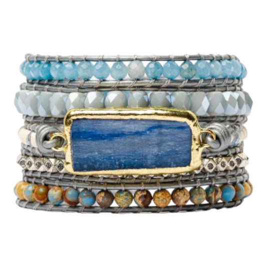 Blue and gold layered bracelets with gemstones.