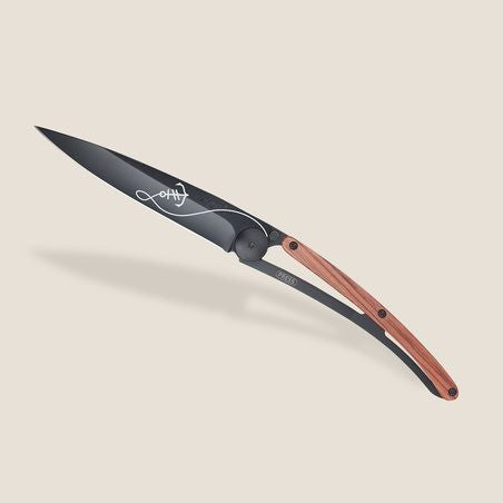 Stylish folding knife with a sleek black blade and wooden handle.