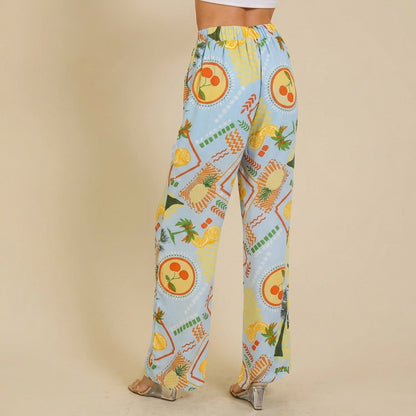 Colorful patterned pants with clear heels on a beige background.