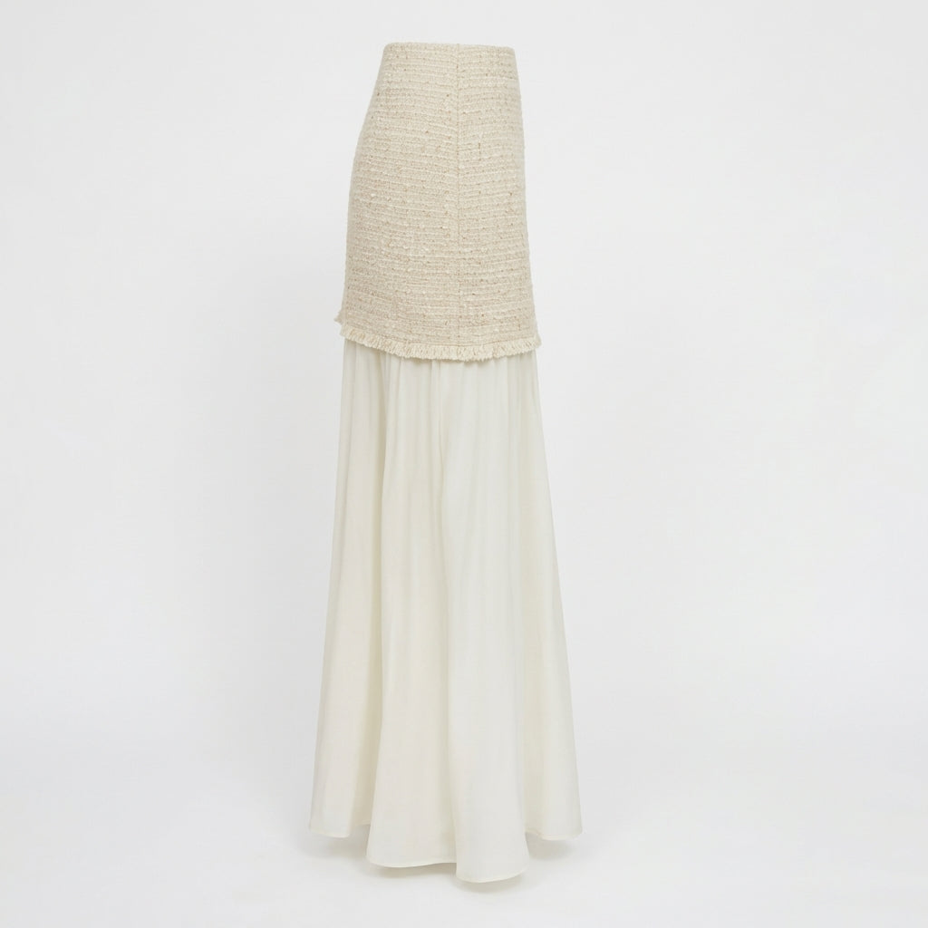 Elegant two-piece dress with textured top and flowing white skirt.