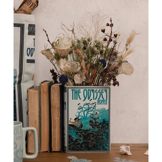 Books and dried flowers in a vase shaped like "The Odyssey."