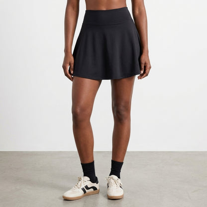 Black flared skirt on a model against a light background.