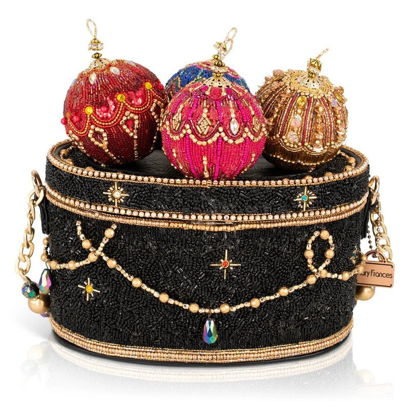 A beaded handbag with ornate, colorful ornaments on top.