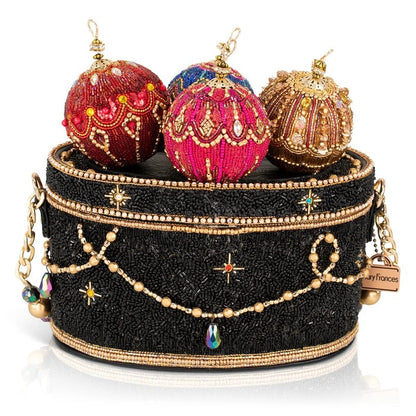 A beaded handbag with ornate, colorful ornaments on top.