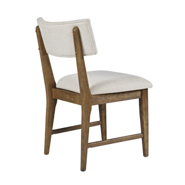 Wooden chair with white cushioned seat and backrest, angled view.