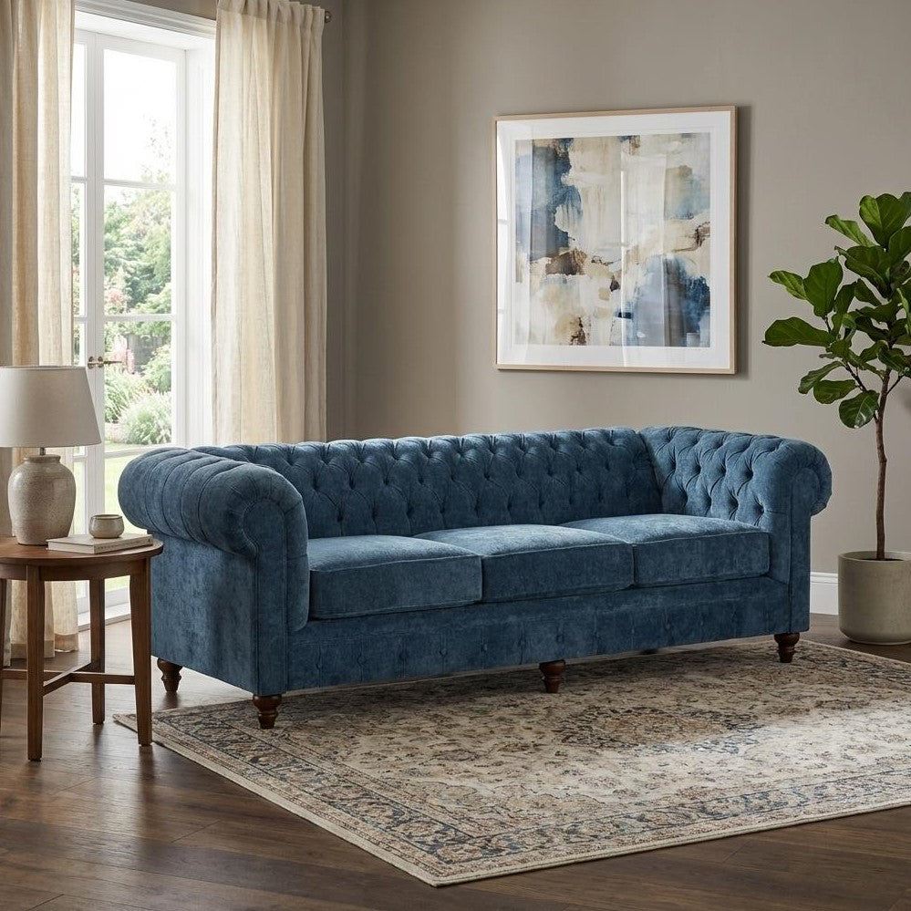 Blue couch, abstract painting, cozy living room setting.