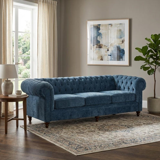 Blue couch, abstract painting, cozy living room setting.