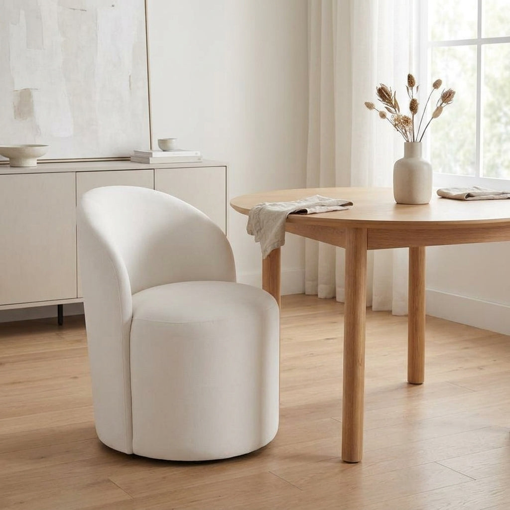 Minimalist dining room with a round table and white chair.