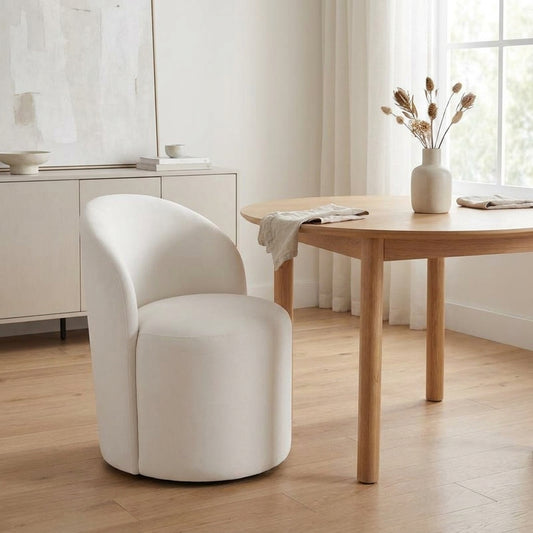 Minimalist dining room with a round table and white chair.