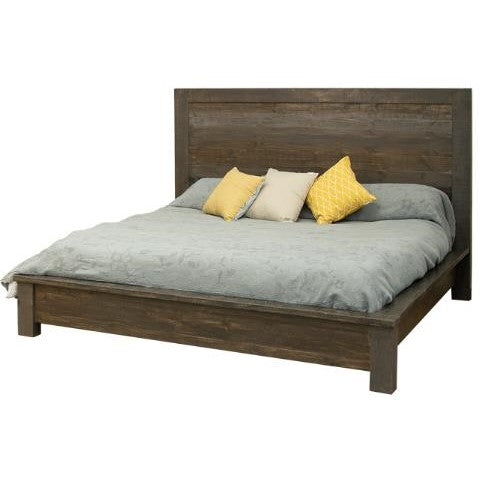 Wooden bed with gray comforter and yellow accent pillows.